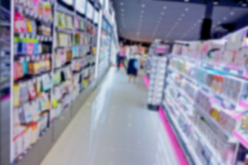 Fototapeta premium Abstract blur shopping mall background,abstract super blurry cosmetic shop in shopping store with bokeh. Modern working space blur background