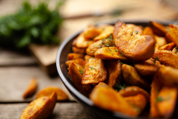 Baked potato fries on wooden table