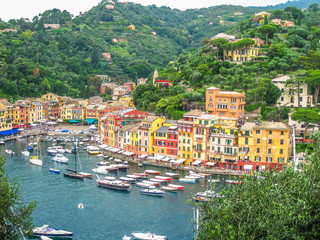 Fototapeta na wymiar Aerial view of Portofino, a famous vacation resort with a picturesque harbor, luxury yachts and celebrity. Italian fishing village, provinces Genoa, Italy.