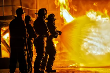 Schilderijen op glas JOHANNESBURG, SOUTH AFRICA - MAY, 2018 Firefighters spraying down fire during firefighting training exercise © Arisha Ray Singh