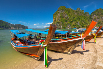 Fototapeta premium Long Tail Boat, traditional wooden boats, in James Bond island, Khao Phing Kan, Phang Nga Bay, Ao Phang Nga National Park, Krabi Province, Thailand.