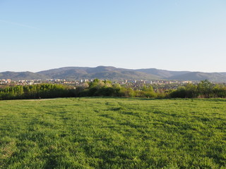 Obraz premium Wonderful panorama of cityscape european Bielsko-Biala city and countryside landscape of grassy field at Beskids, POLAND
