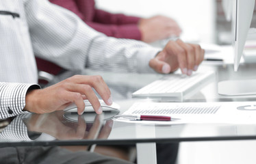 Close-up of male hands using laptop at office