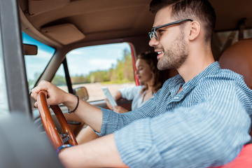 young couple driving car during road trip