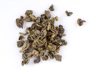 Oolong tea To Guanine in round shape isolated. Green tea background. Dry Green Tea Leaves isolated on White Background