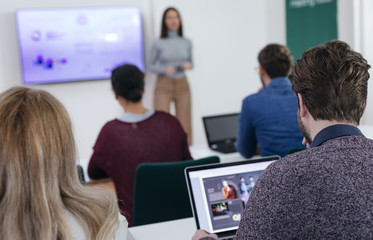 Businesswoman Presenting in Front of Audience