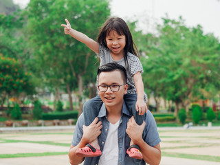 Father and daughter playing in the park,Happy father's day concept.