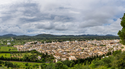Fototapeta na wymiar Mallorca, XXL panoramic view over ancient old town of Arta between green mountains