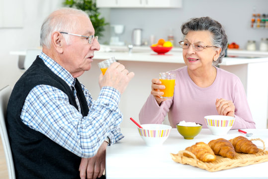 senior couple enjoying breakfast at home