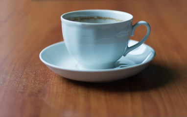 white coffee Cup on the table with traces of foam on the edges
