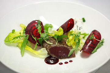 marinated beef with beet and sauce from cranberry on white plate for restaurant menu