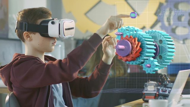 In a Computer Science Class Boy Wearing Virtual Reality Headset Works in Interactive 3D Environment. Mechanical Modeling Project of Connecting Gears with Augmented Reality Software. 4K UHD. - Powered by Adobe