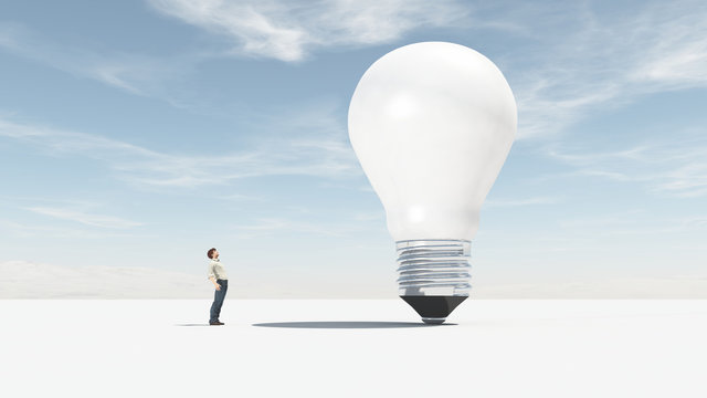 The man looks up towards a big bulb.