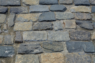 granite stone pavement texture. Abstract background of old cobble stone pavement closeup.