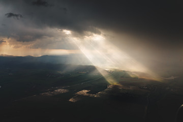 Dramatic aerial view of storm clouds with light ray and sun beam