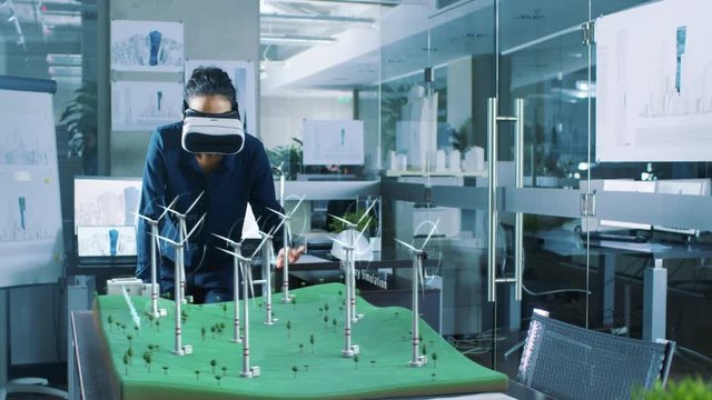 Futuristic Female Engineer using Virtual Reality Environment for Designing and Testing Wind Turbines in 3D. Renewable Energy Concept. Shot on RED EPIC-W 8K Helium Cinema Camera.
