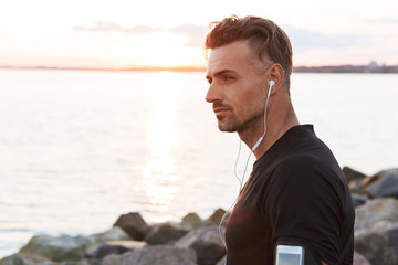 Close up portrait of a focused sportsman listening to music