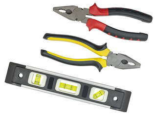 Spirit level and pliers on white © AVD