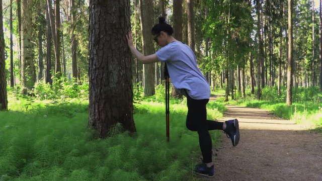 Woman hiker warm up before Nordic walking