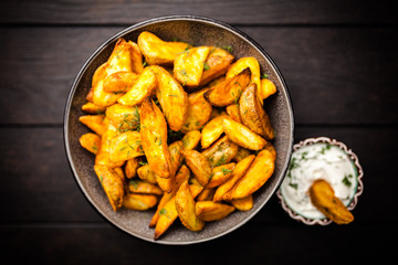 Baked potato fries on wooden table
