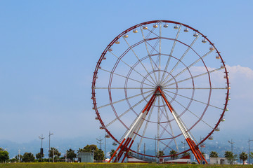 Ferris wheel on embankment of Batumi at sunny day