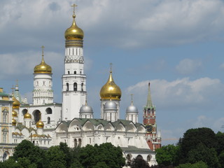 Fototapeta na wymiar Ivan the Great bell tower against a cloudy blue sky, a masterpiece of Russian architecture. Moscow Kremlin in summer