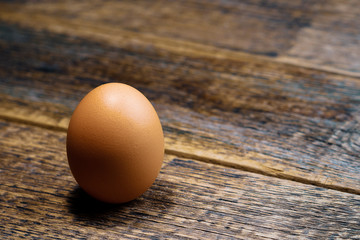 chicken egg brown on the background of an old wooden surface