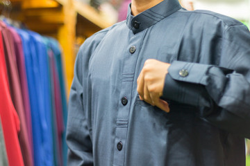 People shopping to prepare for Eid celebration at clothes booth.