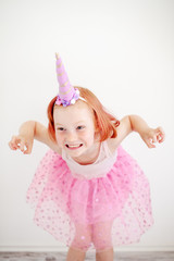 A girl in a unicorn suit is crooked