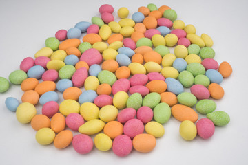 Fototapeta na wymiar Small colorful chocolate candies on a white background
