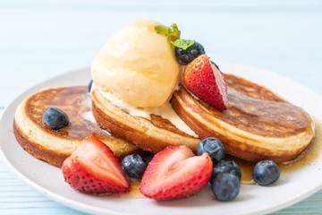 pancake with blueberries, strawberries, honey and vanilla ice-cream