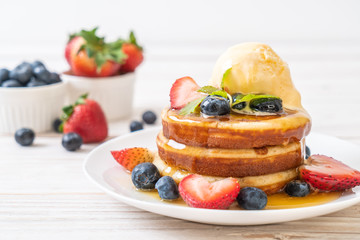 pancake with blueberries, strawberries, honey and vanilla ice-cream