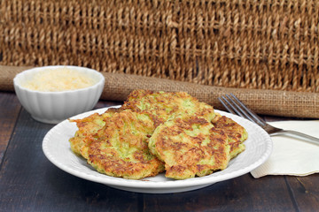Zucchini Fritters with a side of Parmesan cheese.