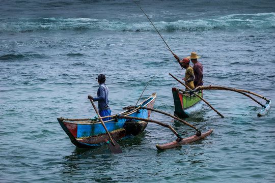Eine Gruppe von Fischern mit Fischerbooten an der Küste von Sri Lanka