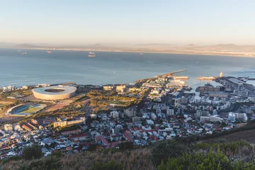 Gordijnen Late afternoon view of Green Point Stadium and Cape Town harbour © bradleyvdw