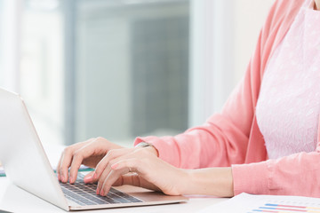 attractive businesswoman sitting working on laptop her small business from home