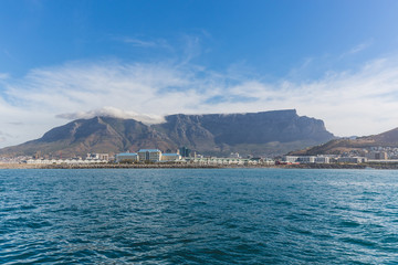 View of Table Mountain in Cape Town from the ocean with blue sky