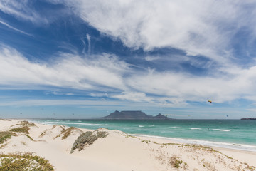 View of Table Mountain from Blouberg in Cape Town with wind surfers