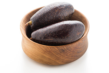avocado on wood plate isolated on white background
