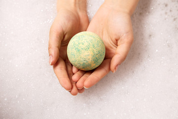 ball of salt dissolves in water. Colored bath bombs