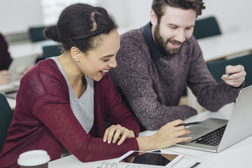 Man and Woman Working Together in Office