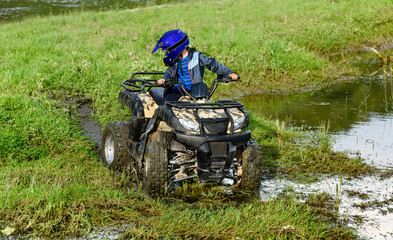 The boy is traveling on an ATV. © Ахтем