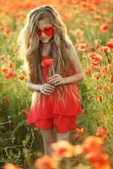 Children in a field with flowers 
