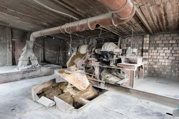 The aggregate distribution of materials for the production of concrete in the old Soviet factory.