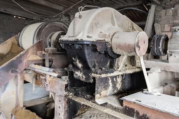 The aggregate distribution of materials for the production of concrete in the old Soviet factory.