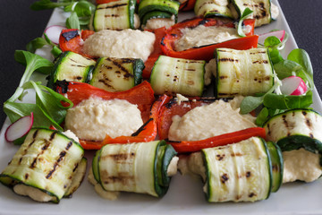 Grilled peppers and zucchini with hummus sauce. A mixture of Mediterranean and Arabic cuisine. Homemade cooking.