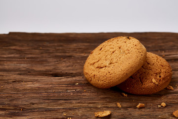 Pile of oat cookies on wooden table, close-up, selective focus.