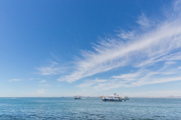 Yachts and small boats in the ocean near the shore