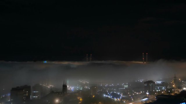 Vladivostok cityscape night view. Fog over the city.