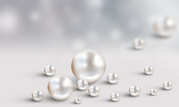 Many scattered white pearls on grey and white cloudy blur background
